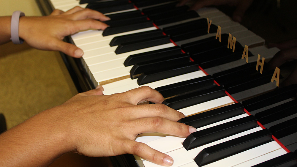 image of hands playing the piano