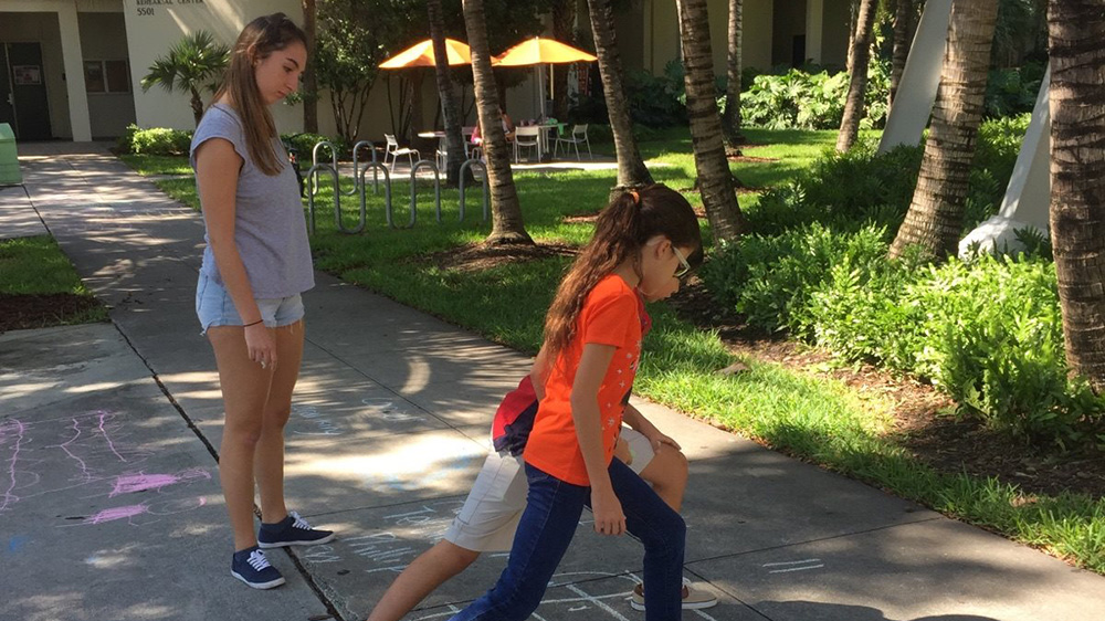 students play hopscotch on campus
