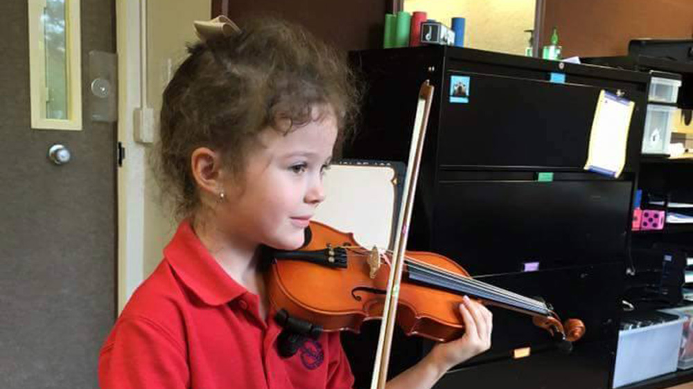 student practices the violin