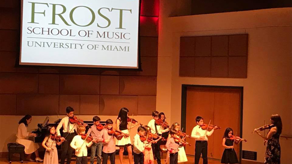 student strings group performs on stage
